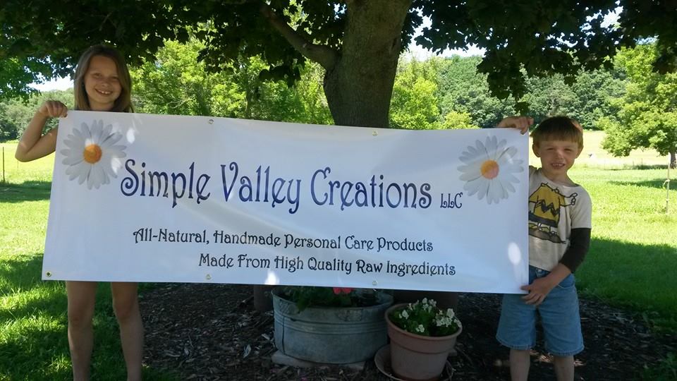 Many things to be proud of! Kids holding banner.